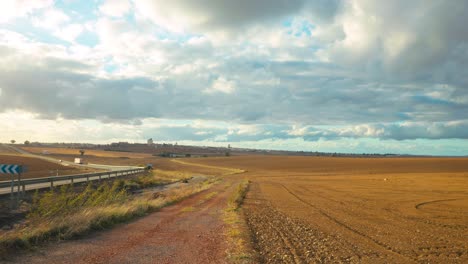 Timelapse-near-a-village-in-Extremeadura,-Spain,-over-the-fields-and-rainy-clouds-passing-by