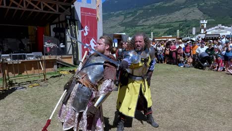 A-comical-fighting-scene-with-weapons-performed-by-Burdyri,-a-professional-sword-and-stage-combat-team,-during-the-South-Tyrolean-Medieval-Games-2023