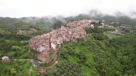 Aerial-establishing-toward-unique-Italian-town-on-narrow-ridge,-Italy