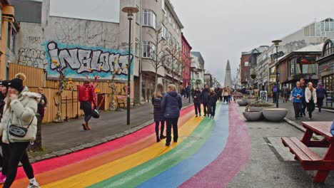 Tourists-walking-around-Rainbow-Street-in-downtown-Reykjavik,-Iceland-on-a-cold-autumn-day