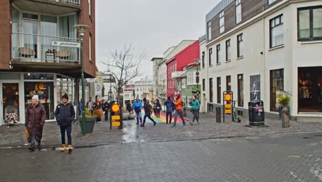 Tilt-down-to-Rainbow-street-in-Iceland-with-tourists-walking-around