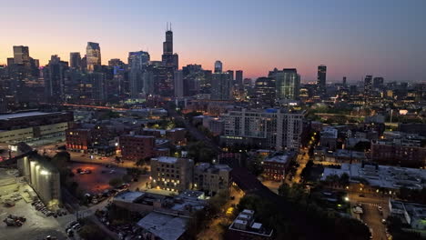 Drone-hyperlapse-over-the-streets-of-River-West-and-Fulton-River,-dusk-in-Chicago