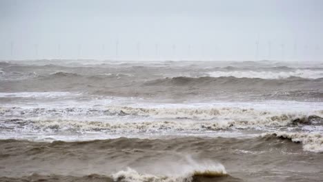 Offshore-wind-turbines-can-be-just-made-out-on-the-horizon-as-threatening-and-choppy-waves-are-whipped-up-by-strong-winds-roll-in-as-Storm-Ciarán-makes-landfall