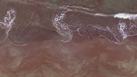 Beautiful-shallow-swirling-waves-on-a-sandy-orange-and-brown-sandbar-or-shoal