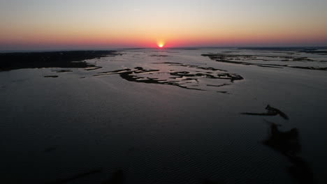 Aerial-shot-of-the-sun-setting-over-Bogue-Sound-in-North-Carolina