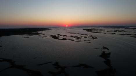 Sun-setting-over-Bogue-Sound-in-North-Carolina,-Aerial,-Drone