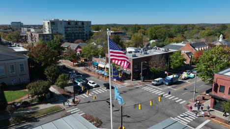 American,-North-Carolina,-and-UNC-flags-waving-in-downtown-Chapel-Hill,-NC