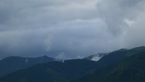 Mountainous-range-horizon,-misty-morning-clouds-swirling