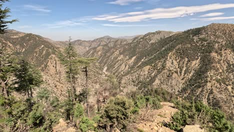 Explore-the-breathtaking-landscape-of-Bouiblane's-Atlas-Mountains,-where-diverse-forests-cloak-the-steep-slopes-in-Morocco's-natural-wonder