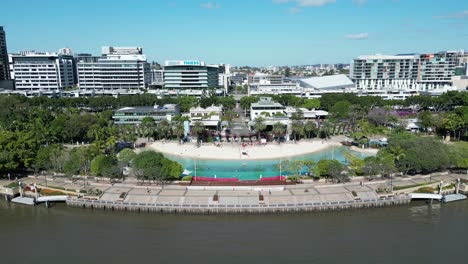 Aerial-footage-of-South-Bank,-South-Brisbane,-taken-at-mid-day,-with-South-Bank-Beach,-Parklands-and-Brisbane-River