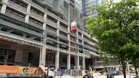External-Lift-Moving-Down-At-Construction-Site-Of-Central-Boulevard-Towers-In-Downtown-Singapore