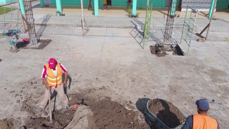 Labor-at-work-using-wheelbarrow-and-pick-axe-in-Ecatepec-de-Morelos,-Mexico