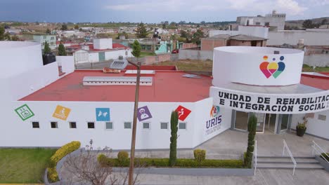 A-remarkable-and-splendid-aerial-view-captures-the-enchanting-design-of-a-rehabilitation-center-and-its-vibrant-surroundings-in-Ecatepec-de-Morelos,-Mexico
