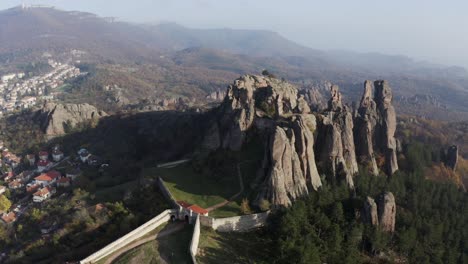 Aerial-drone-approach-of-the-sculptural-rock-formations-of-Belogradchik-cliff,-a-medieval-fortress-situated-in-the-foothills-of-Balkan-mountains,-in-the-province-of-Vidin-in-Northwestern-Bulgaria