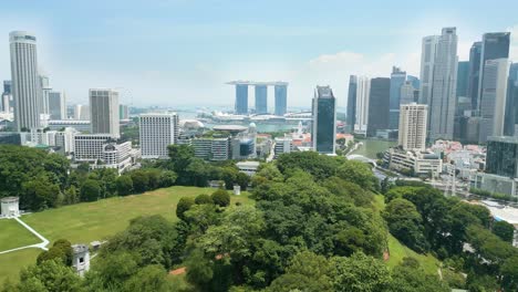 Drone-shot-of-Fort-Canning-park-with-views-of-Marina-Bay,-Singapore