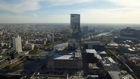 Aerial-tracking-shot-of-the-FMC-tower-and-the-University-city,-in-sunny-Philadelphia