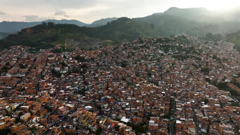 Aerial-view-overlooking-a-dense-community-of-poor-homes-in-Comuna-13,-Colombia