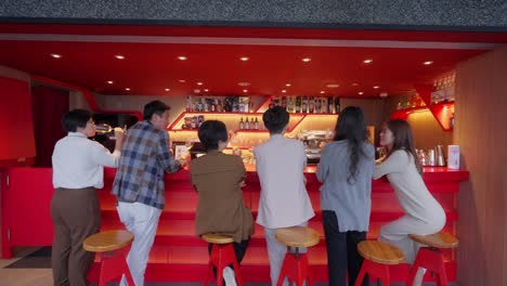 Asian-people-cheering-celebrating-at-red-bar-in-slow-motion