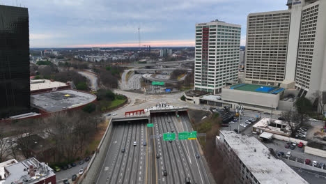 Aerial-birds-eye-view-of-cars-driving-on-multi-lane-freeway-in-Atlanta-city,-Downtown-Atlanta-traffic-highway-transportation-in-the-evening
