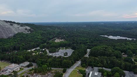 Aerial-panorama-view-of-Stone-Mountain-surrounded-by-forest-during-cloudy-day