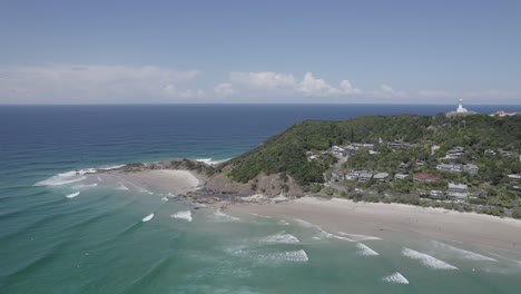 Flying-Over-The-Blue-Sea-Near-The-Wategos-Beach-On-A-Sunny-Day-In-Byron-Bay,-NSW,-Australia