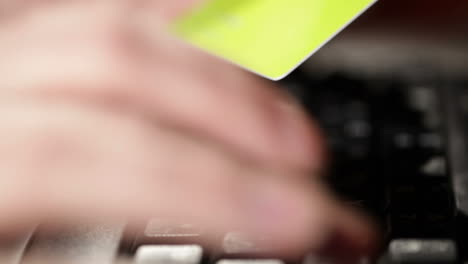 Holding-a-credit-card-and-typing