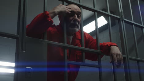 Prison-Guard-Puts-Handcuffs-on-Criminal-Through-Metal-Bars----------(Stock-Footage)