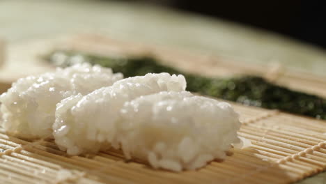Putting-wasabi-on-the-nori-while-cooking-sushi-rolls