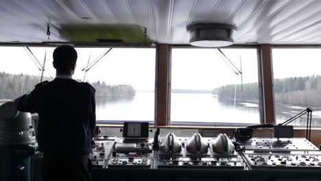 Navigation-officer-driving-ship-on-the-river