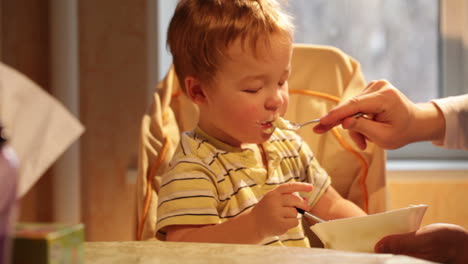 Little-boy-eats-porridge