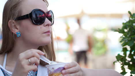 Woman-eating-ice-cream-in-the-street-cafe