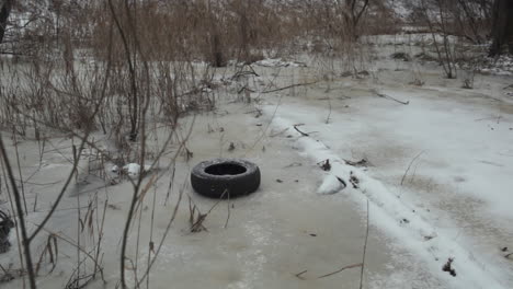Teenager-throwing-used-tire-in-winter-park