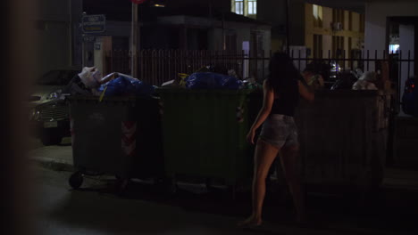 Full-dumpsters-in-the-street-of-small-town-night-view