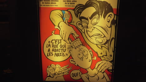 Poster-of-satirical-magazine-Charlie-Hebdo-in-the-street-at-night-Paris-France