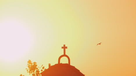 Church-and-flying-bird-against-bright-sunset-shine