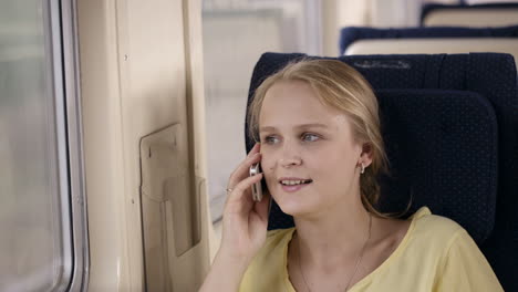 Woman-talking-on-the-phone-in-the-train