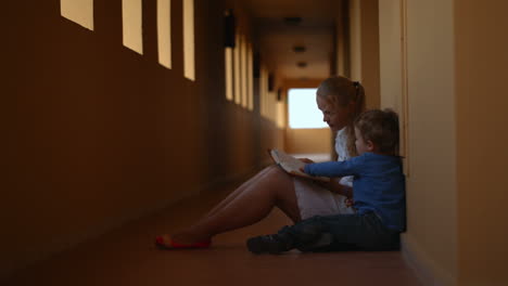 Mother-and-son-with-book-in-hotel-hall