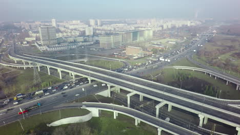 An-aerial-view-of-a-road-interchange-against-the-misty-urban-view
