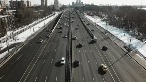Transport-traffic-on-highway-in-winter-city-aerial