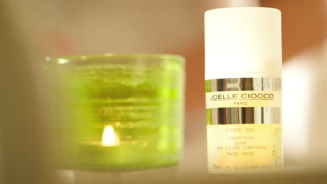 Putting-Joelle-Ciocco-cosmetic-near-burning-candle