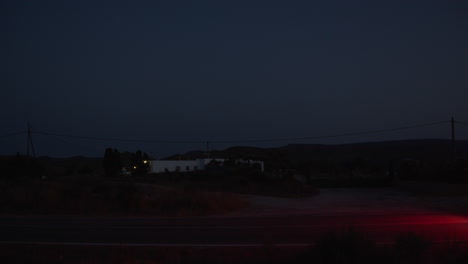 Vista-Nocturna-De-Un-Automóvil-Conduciendo-Por-Una-Remota-Carretera-Rural