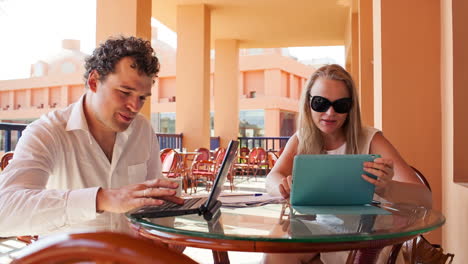 Young-couple-with-laptop-and-pad