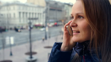 Emotional-woman-having-a-phone-talk-outdoor