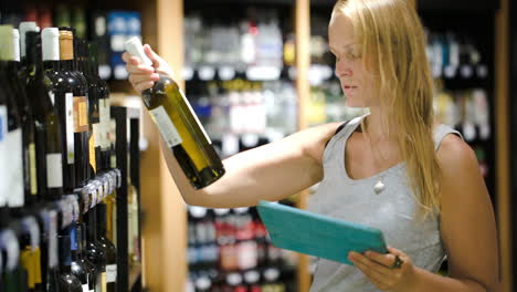 Woman-choosing-wine-using-pad