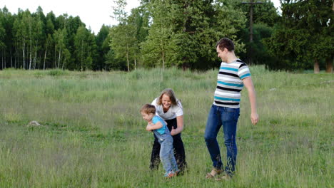 Mother-father-and-son-walking-on-the-meadow