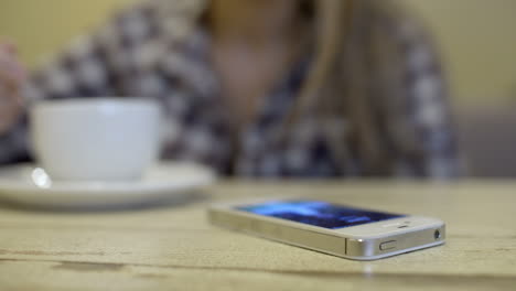 Woman-with-cup-of-tea-receiving-a-call