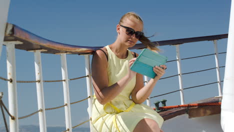 Woman-using-pad-during-sea-traveling