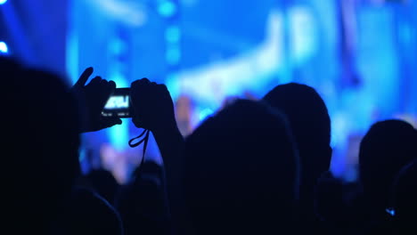 People-takes-photos-on-night-concert