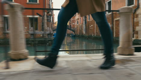 Woman-in-haste-moving-along-Venetian-canal