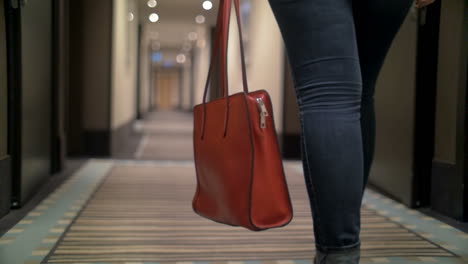 Woman-with-bag-walking-in-hotel-hall